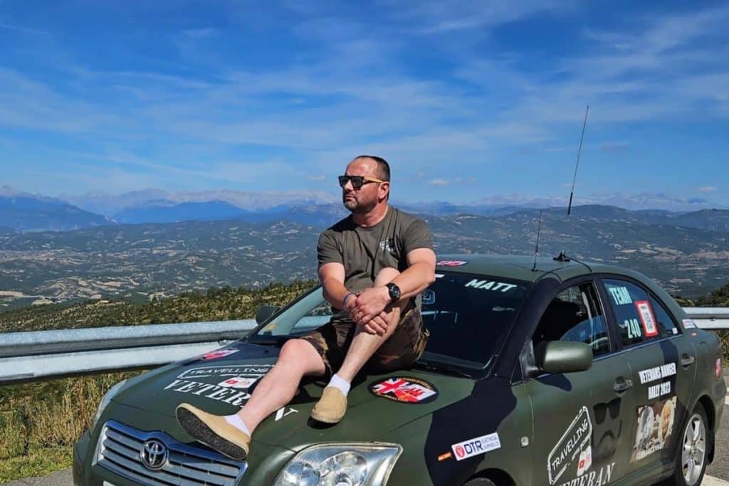 Dean Griffin, the travelling veteran, sitting on a car